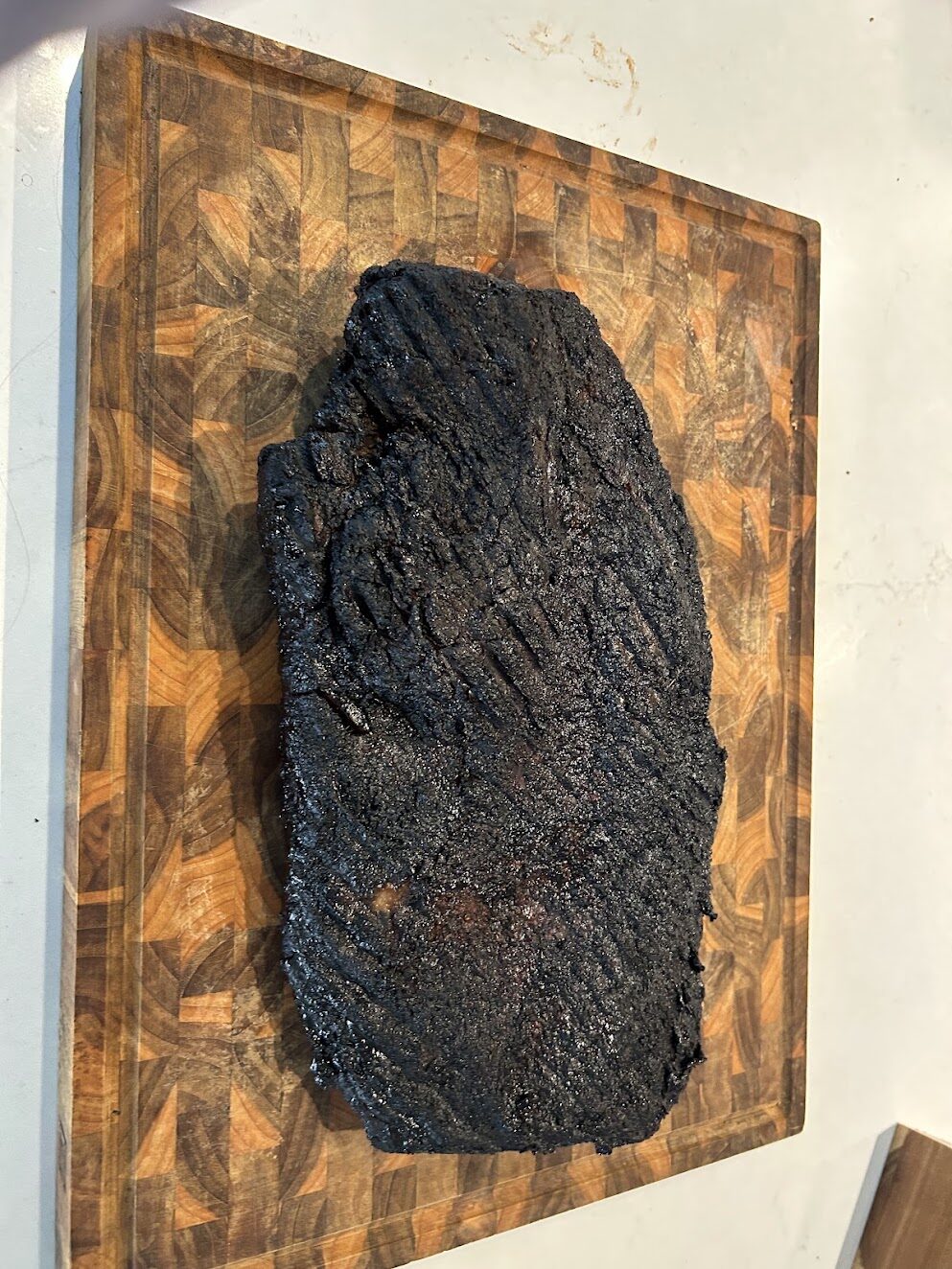 Smoked brisket resting on a cutting board